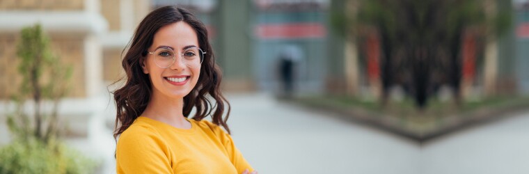 Woman in yellow sweater wearing glasses