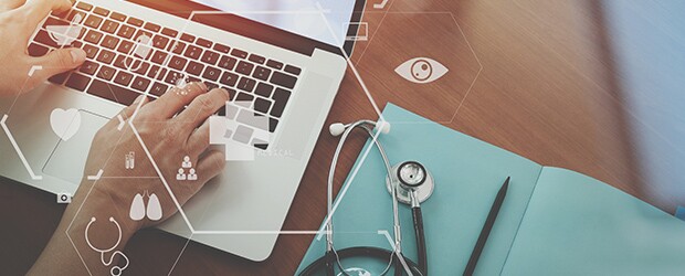 top view of nurse working with stethoscope and laptop