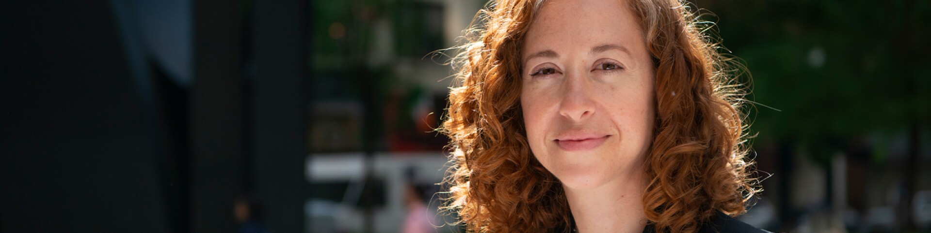 woman looking straight ahead smiling