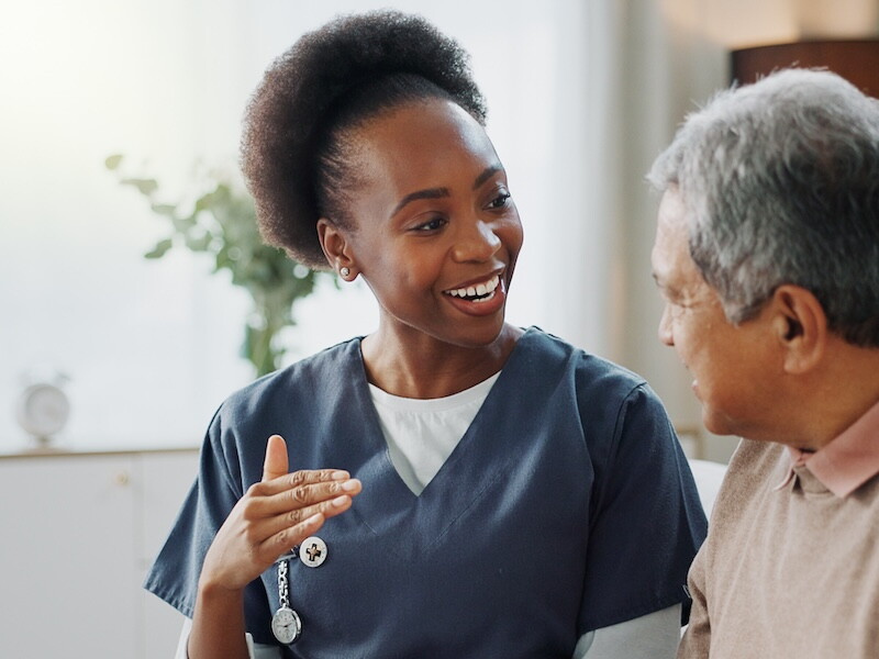 An Allied Health professional enjoys a conversation with a patient