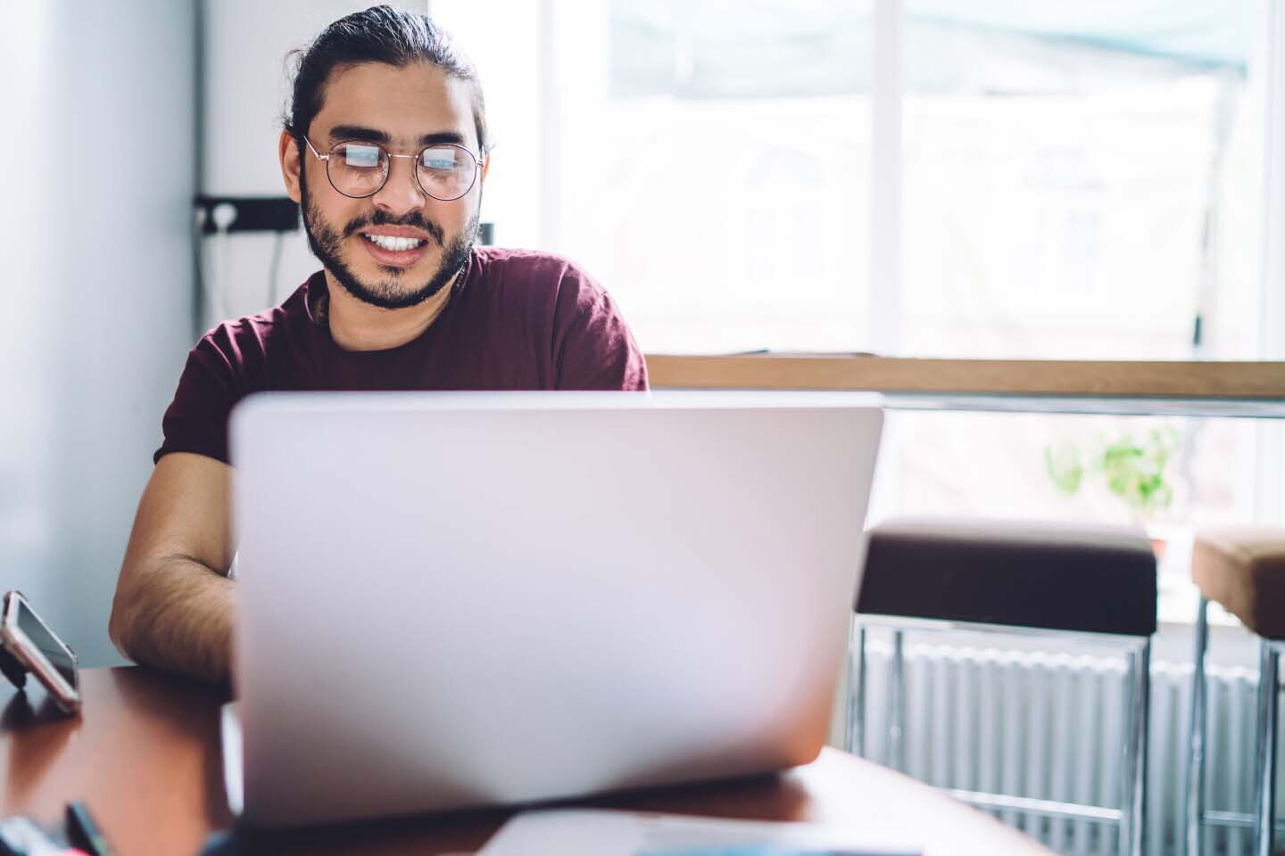 guy in purple shirt working selecting courses on a laptop