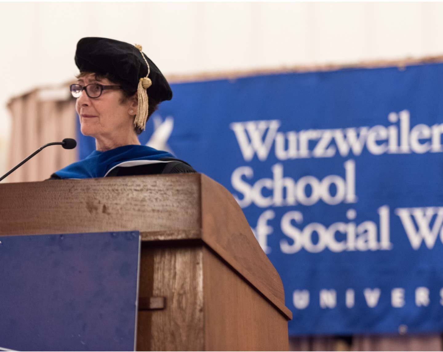 Wuzweiler faculty members speaks at podium