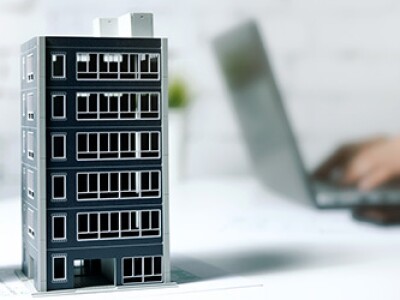 commercial vs. residential real estate, building models, man working