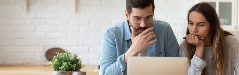 Couple at laptop thinking about their finances