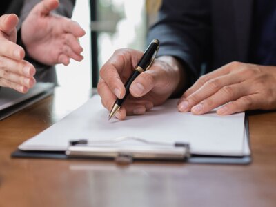 Two Lawyer with Document Paper and Hammer on Wood table.
