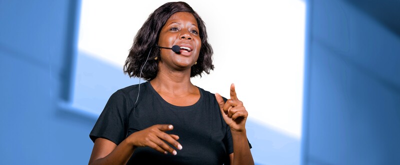 Woman with headset speaking at a conference