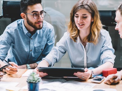 Diverse group professionals sitting around a large conference table