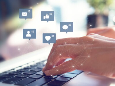 Hands-Typing-Over-Keyboard-With-Social-Icons