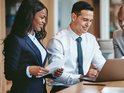 Group of lawyers looking over documents in an office