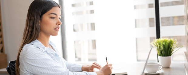 Professional woman working on laptop at her desk