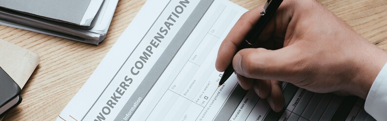 Man filling out a worker's compensation form