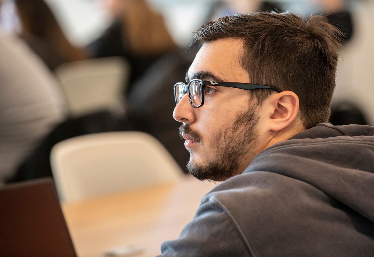 Male student concentrating while in class