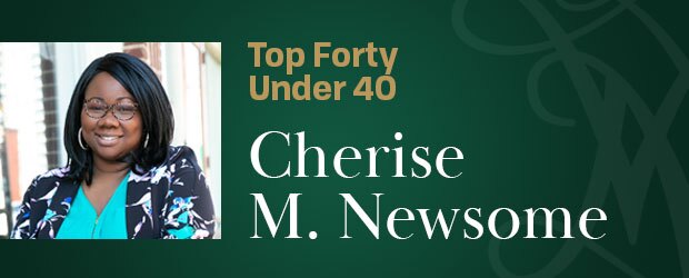 Cherise M. Newsome, MBA ‘23 Candidate,, smiles while enjoying a beautiful day at a cafe patio.