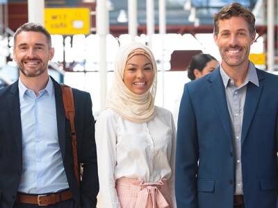 Diverse group of business people standing together in corridor at office
