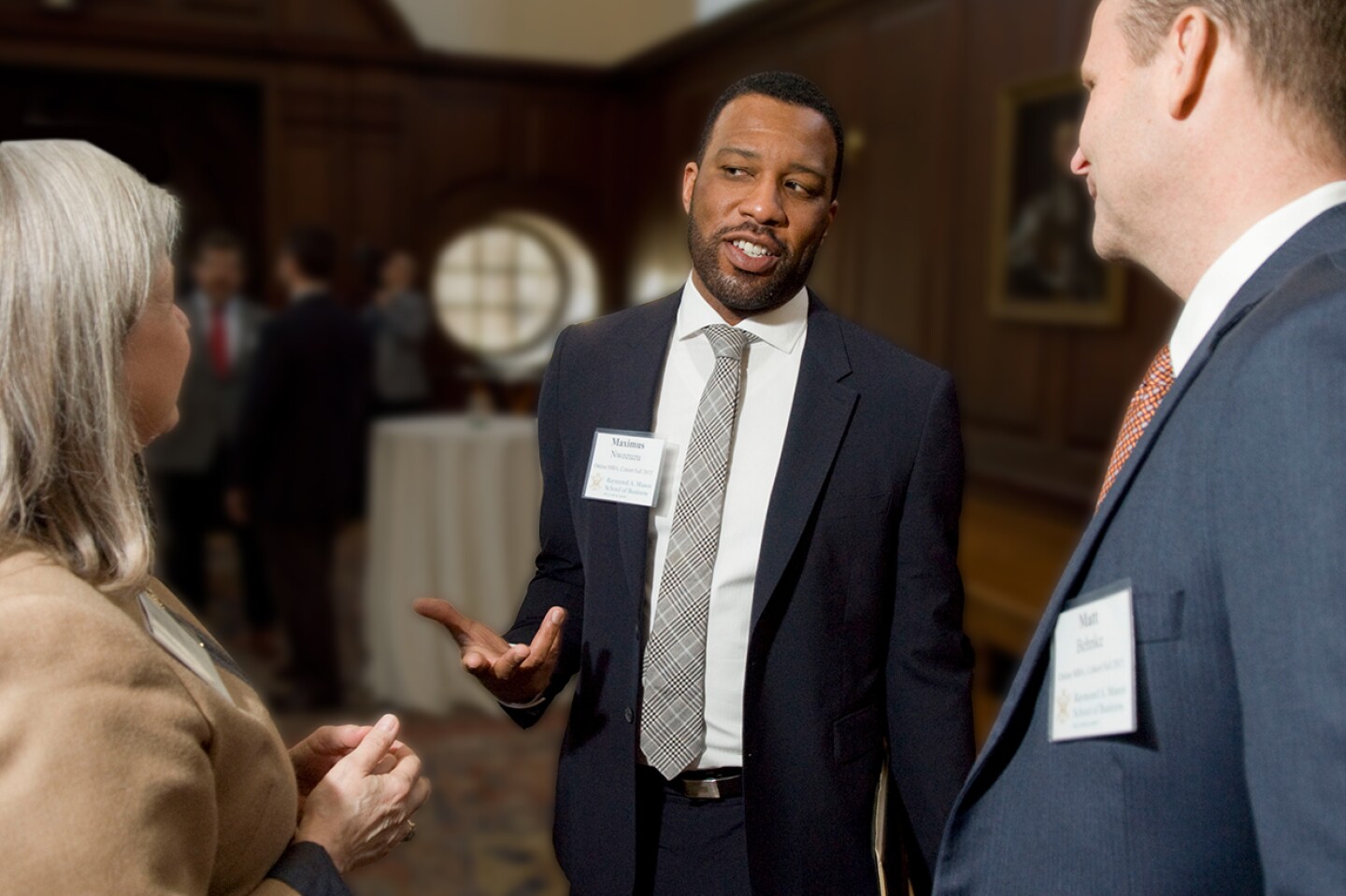 Three people in discussion at a networking event