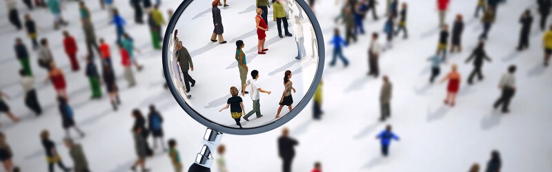 Magnifying glass bringing select people in a crowd into focus