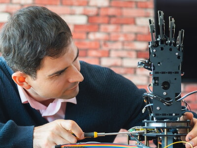 Biomedical engineer working on an articulated prosthetic hand