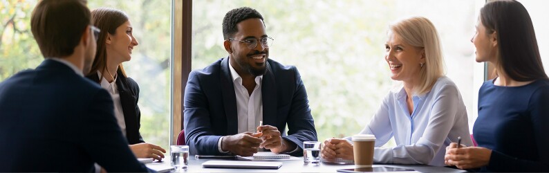 Group of school administrators and teachers meeting around a table