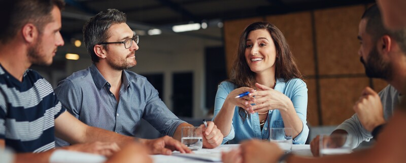Woman leading a meeting in an open plan office