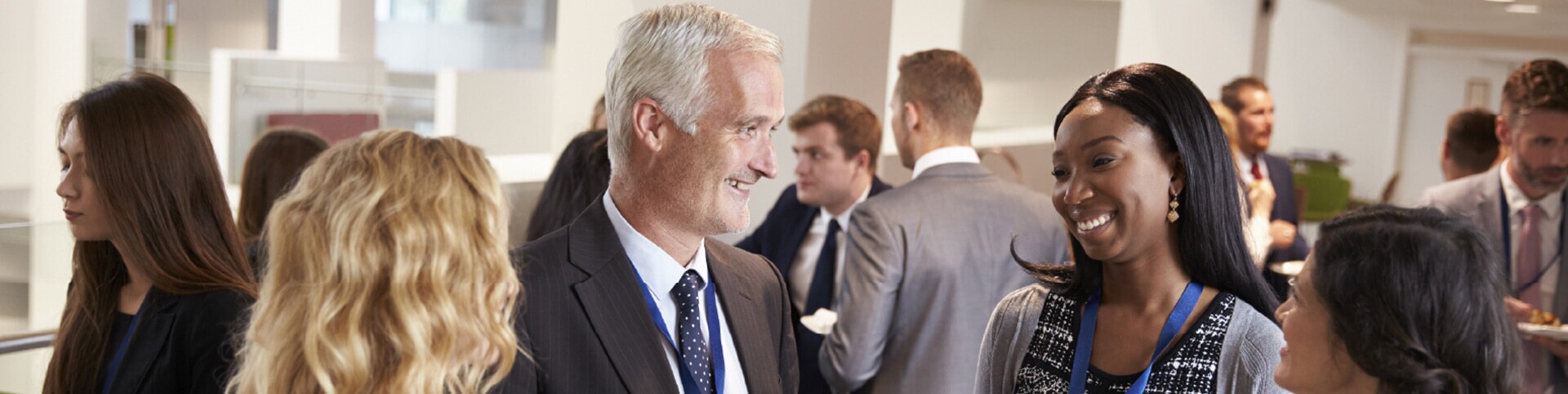A group of four alumni talking at an event