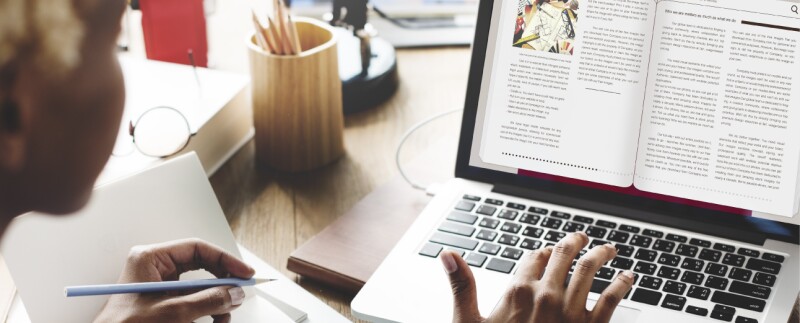 Woman studying e-book on laptop