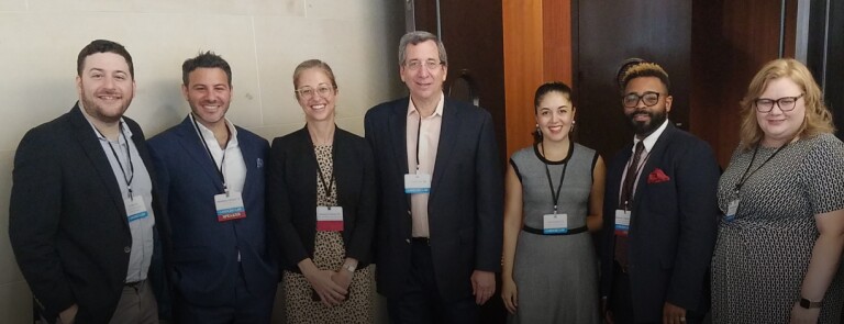 students, faculty, and speakers pose for photo at a Cardozo Law event