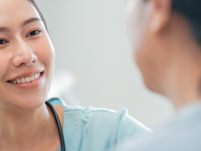 A nurse listens carefully to a patient.