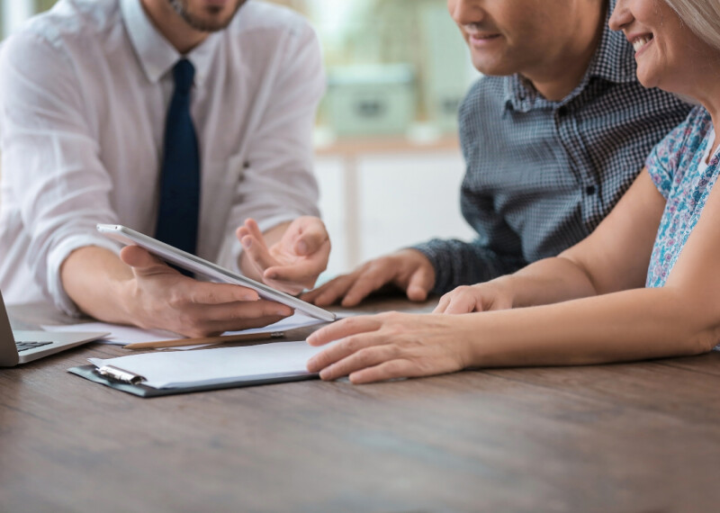 insurance underwriter reviewing policy with couple