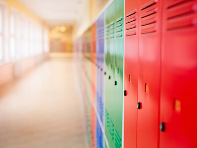 Multicolored row of lockers in school hallway