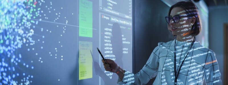 female teacher projecting a presentation with an artificial intelligence neural network architecture.