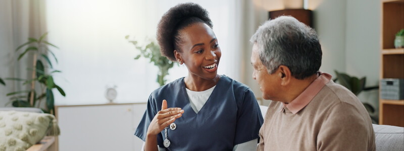 An Allied Health professional enjoys a conversation with a patient
