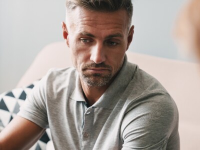 man having a conversation with psychologist during therapy session