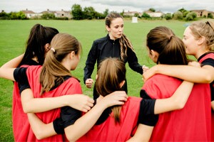 Rugby players and their coach gathering before a match.