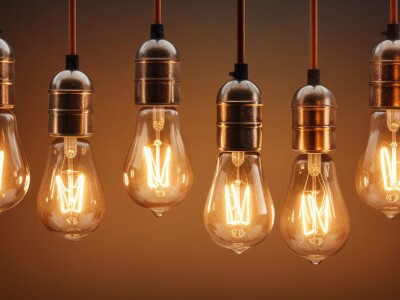 A row of eight vintage light bulbs hanging from the ceiling