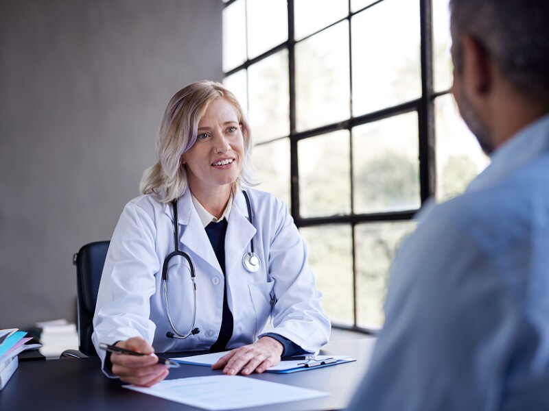 Female doctor talking with administrator