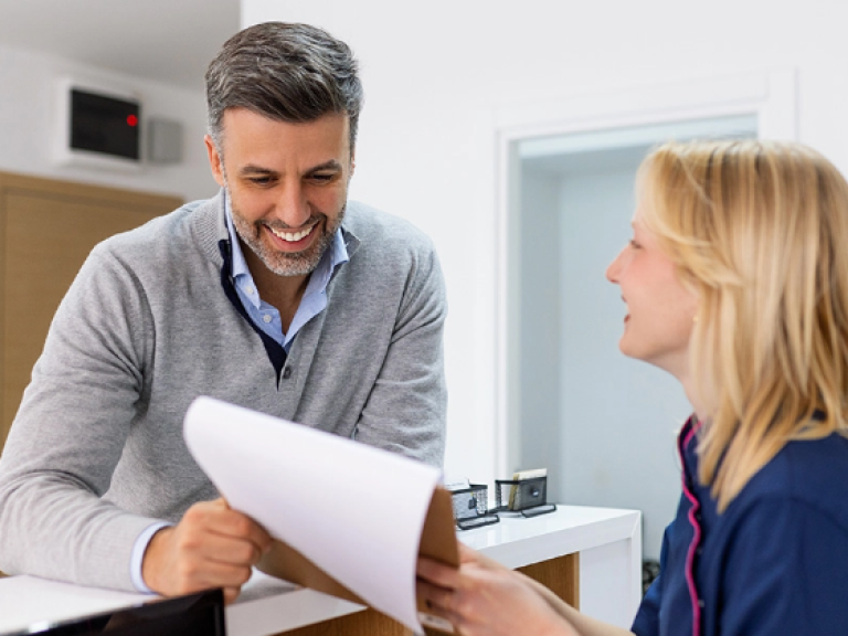 Healthcare compliance specialist consulting with female doctor at desk