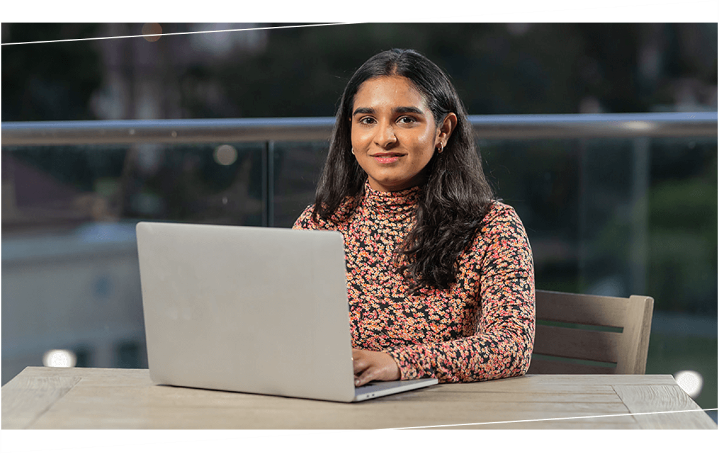 Woman in floral shirt using a laptop