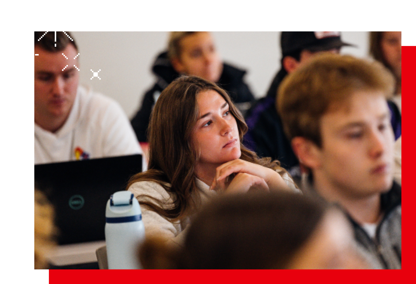 A female KU student is listening to the professor's lecture.