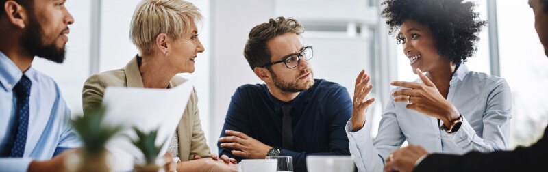 A diverse group of business people meeting over coffee