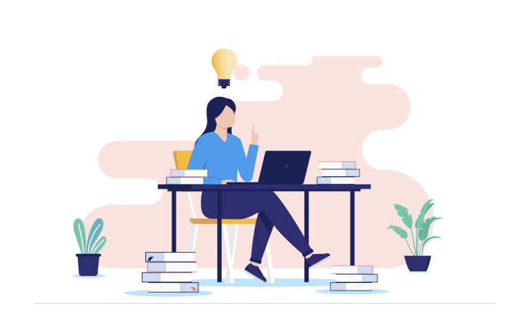 A person sitting at a desk using a laptop.