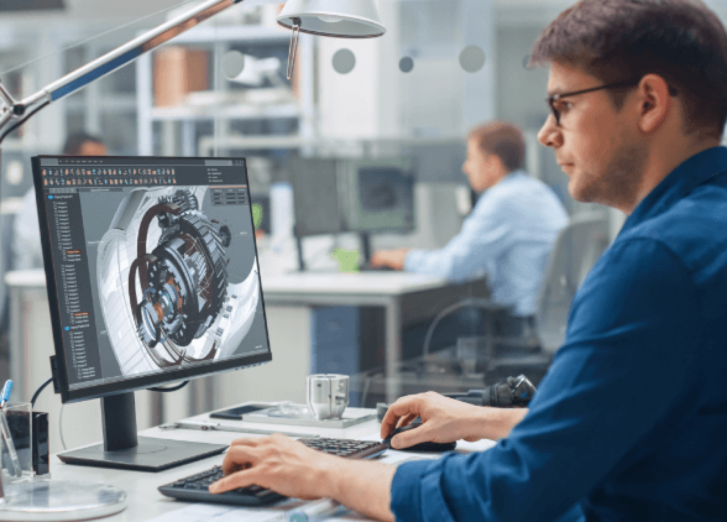 Engineer looking at computer screen and designing an engine