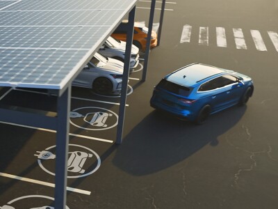 Corporate parking lot featuring solar panels and electric car charging stations
