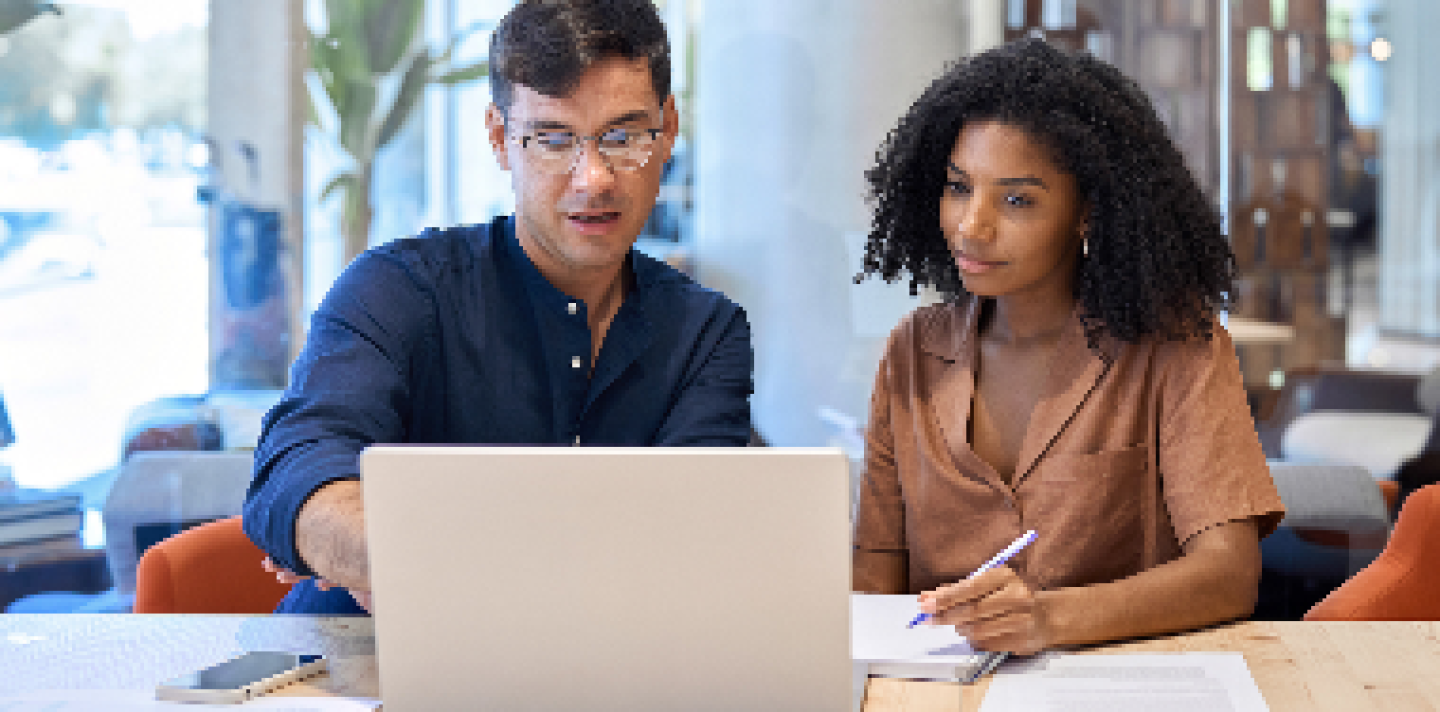woman and a man looking at a laptop together