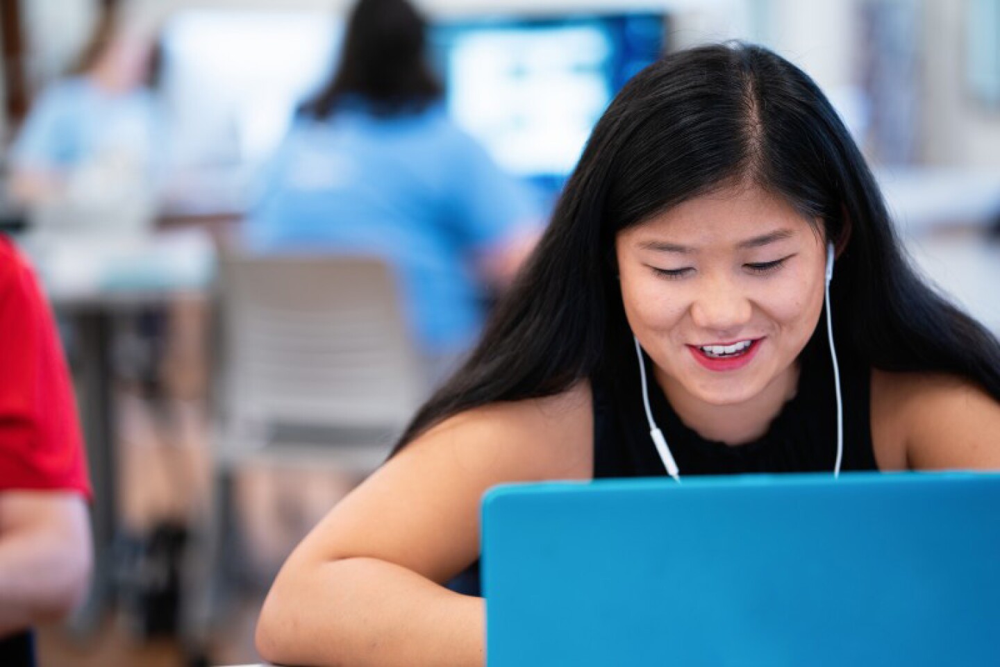 Happy student working on laptop