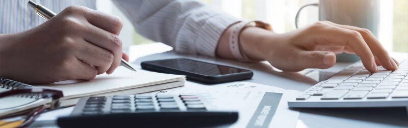 Female accountant using computer to generate financial reports.
