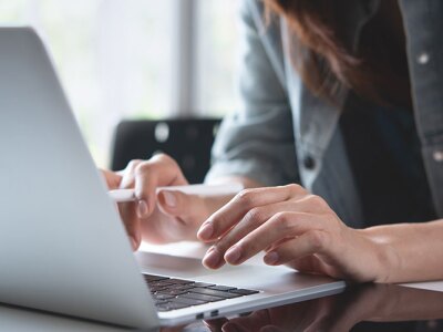 Businesswoman online working on a laptop computer.