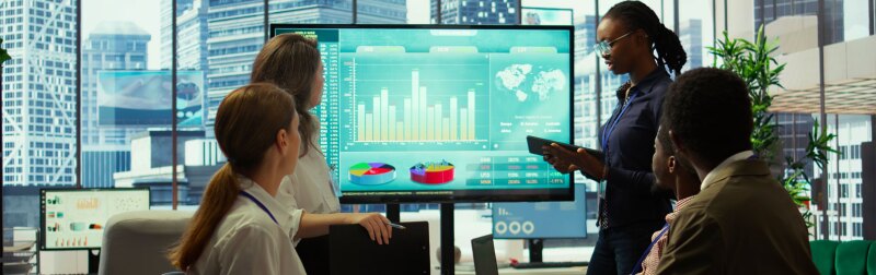 Business team presenting infographics and digital marketing insights for growth, showcasing the impact of recent campaigns and outlining plans for future development initiatives in workspace.