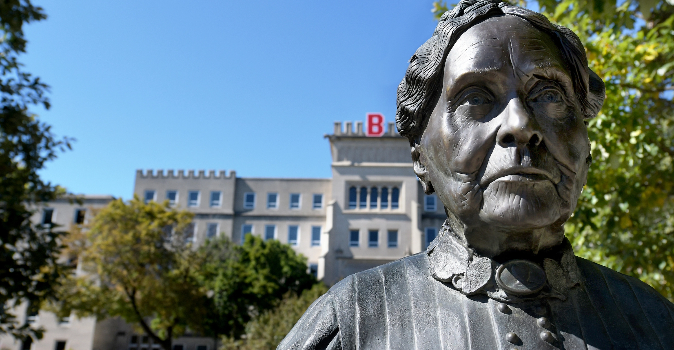 Statue of Lydia Moss Bradley with a Bradley building in the distance