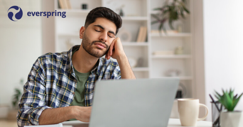 Student on computer closing eyes