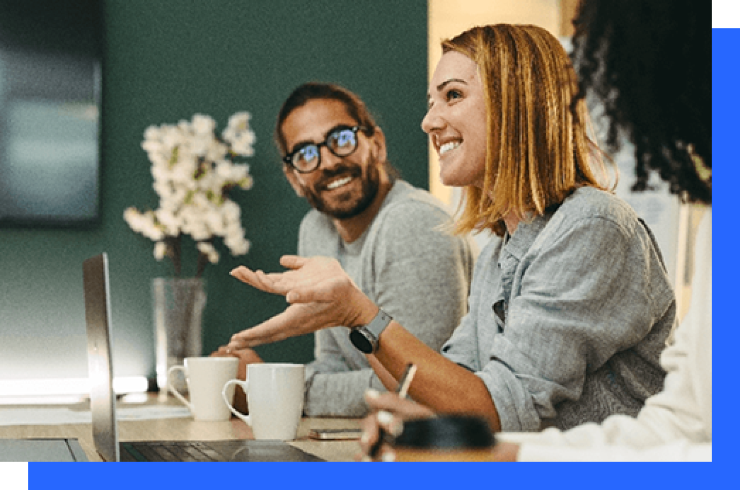 Female student smiling in conversation with colleagues.